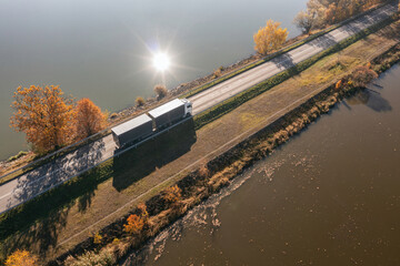 Truck goes on the road in autumn. car transport . Truck with semi-trailer in gray color.  Transport...