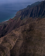 Aerial Na Pali Coast State Park on Kauai, Hawaii. High quality photo.  People hiking Awa'awapuhi Trail. Beautiful mountain backdrop of Hawaii's Na Pali Coastline with 1,000 foot steep cliffs. Sunset