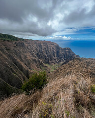 Aerial Na Pali Coast State Park on Kauai, Hawaii. High quality photo.  People hiking Awa'awapuhi Trail. Beautiful mountain backdrop of Hawaii's Na Pali Coastline with 1,000 foot steep cliffs. Sunset