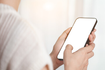 Asian woman's hand using a smartphone with blank white screen