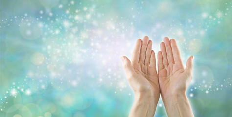 Reiki Healer channeling high resonance Healing Energy - female open palm hands against a pastel green sparkling bokeh effect background with space for  messages or business card template
 - obrazy, fototapety, plakaty