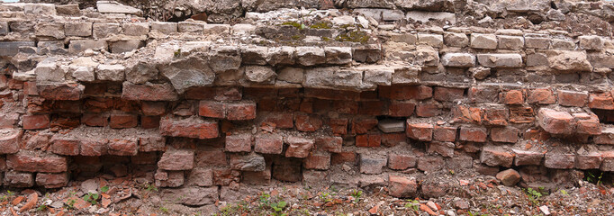 the crumbling brick foundation of the building