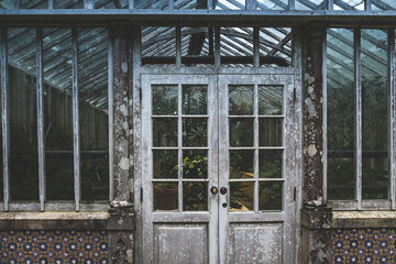 Front of an old, rusty and vintage looking greenhouse in Pena Park, Sintra, Portugal