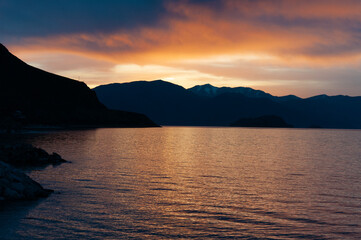 Lovely sunset over the sea, cloud the evening sky and mountain