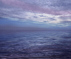 Obraz premium Beautiful atmospheric romantic cloudscape ocean horizon - lilac blue sea and moody clouds background ideal for a holistic, spiritual or holiday theme with cool calming colours and copy space for messa