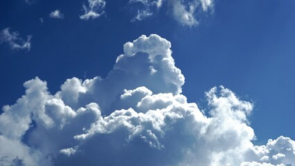 Naklejka na ściany i meble white cumulus clouds against blue sky
