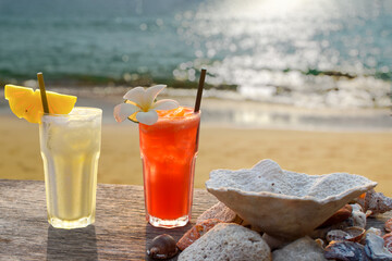 two drinks with a tropical beach in the background