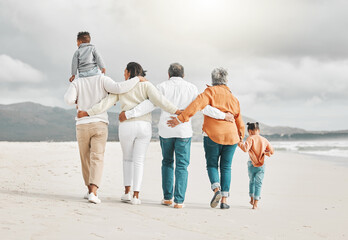 The beach is fun for the whole family. Rearview shot of an affectionate family of six on the beach.