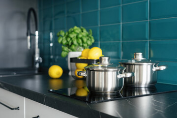 cookware at kitchen with glass ceramic stove and modern interior