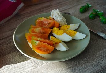vegetables tomatoes eggs on plate in breakfast