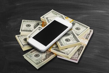 Blank screen smartphone placed on money