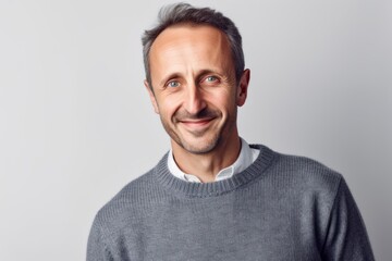 Obraz premium Portrait of a handsome middle-aged man in a gray sweater