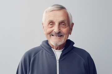 Obraz premium Portrait of smiling senior man in sportswear looking at camera