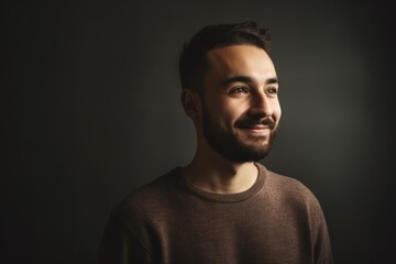 Obraz premium Portrait of a handsome young man on dark background with copy space