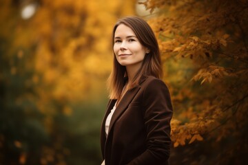 Beautiful young woman walking in the autumn park. Outdoor portrait.
