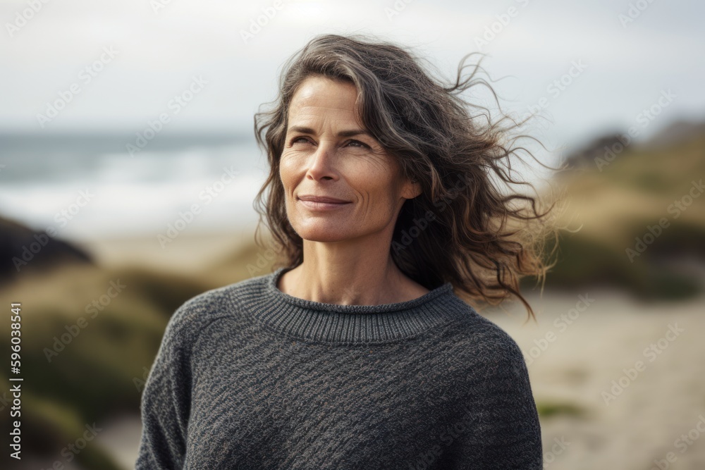 Poster Lifestyle portrait photography of a pleased woman in her 40s wearing a cozy sweater against a summer landscape or beach background. Generative AI