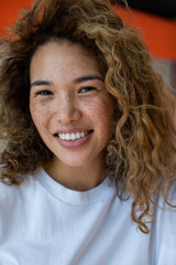 Attractive curly woman with freckles.