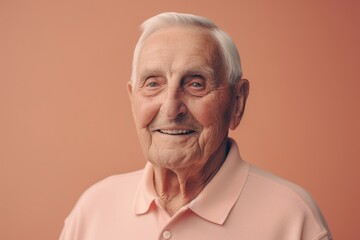 Obraz premium Portrait of smiling senior man. Isolated on orange background.
