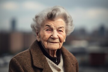 Portrait of an elderly woman on the background of the city.