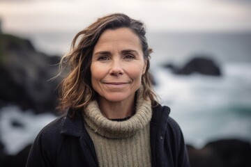 Portrait of mature woman standing in front of the camera at the beach