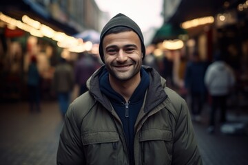 Fototapeta premium Portrait of a handsome young man with a beard in a hat on the street