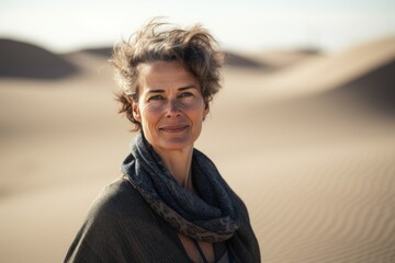 Portrait of middle aged woman with scarf in the middle of the desert