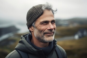 Medium shot portrait photography of a pleased man in his 50s wearing a cozy sweater against a bird's-eye view or aerial landscape background. Generative AI