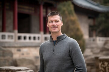 Obraz premium Portrait of a handsome man smiling at the camera in a temple