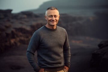 Portrait of a handsome middle-aged man on the background of a volcanic landscape