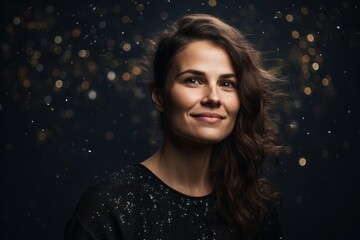Portrait of a beautiful young woman on a black background with lights