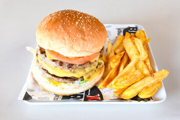 Big tasty burger with beef cutlet on a plate