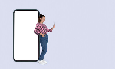 Cool stylish millennial woman using nice mobile app