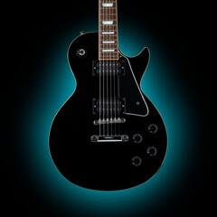 Fototapeta na wymiar Black guitar isolated on dark blue background