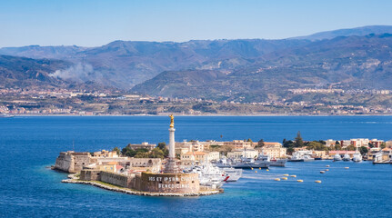 Naklejka na ściany i meble The Strait of Messina between Sicily and Italy. View from Messina town with golden statue of Madonna della Lettera and entrance to harbour. Calabria coastline in background