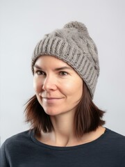 Portrait of a beautiful young woman in a gray knitted hat