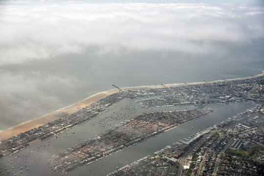 Newport beach aerial view as sea mist is building shortly after take off from John Wayne Airport