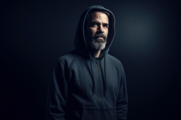 Full-length portrait photography of a pleased man in his 40s wearing a stylish hoodie against an abstract background. Generative AI