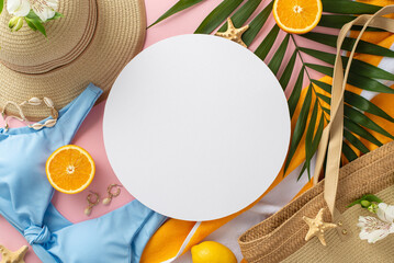 Summer dreams! Top view flat lay of blue swimsuit with sunhat, green palm leaves, earrings, bracelet, and bag on pastel pink background with empty circle for text or advert