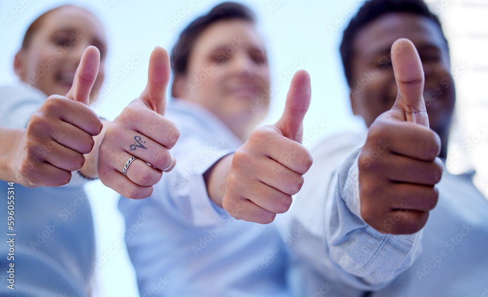 Poster well back that three times over. low angle shot of three unrecognizable businesspeople giving thumbs