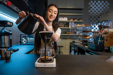 Fototapeta premium Concentrated coffeehouse brewing pour-over coffee at the counter