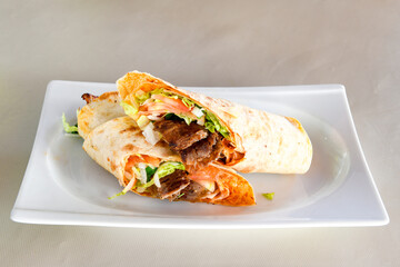 Lavash doner kebab ( zurna doner durum )  or shawarma sliced in plate isolated. 
