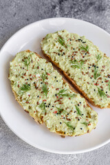Grilled toast with avocado paste, eggs, cream cheese, salt, spices and herbs