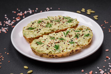 Grilled toast with avocado paste, eggs, cream cheese, salt, spices and herbs