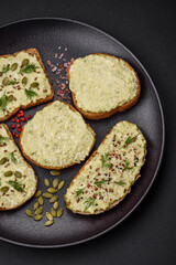 Grilled toast with avocado paste, eggs, cream cheese, salt, spices and herbs