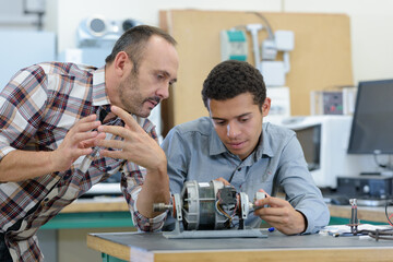 young attractive students of mechatronics working on project