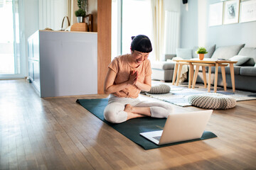 Young Japanese woman doing yoga at home