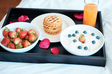 Breakfast is served. High angle shot of a healthy breakfast on a tray in a bedroom.