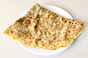 Freshly baked appetizing Turkish tortillas - Gozleme with spinach, cheese  on a wooden board. Space for text. Shallow depth of  field. Handmade Turkish traditional pastries.