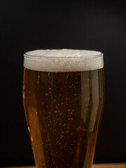 Glass of beer on a black background.