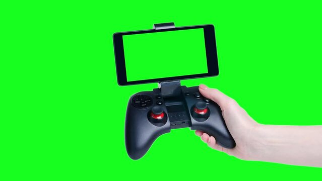 Hand holding showing gamepad with smartphone isolation, green screen background
